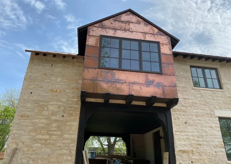 Copper metal panel facade on a stone building for Skylight Installation in Safety Harbor