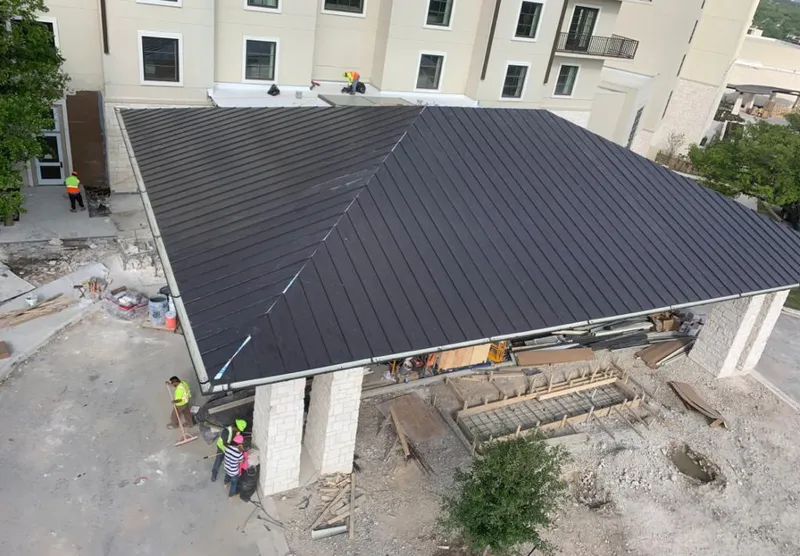 Metal roofing installation team working on a commercial building in Safety Harbor